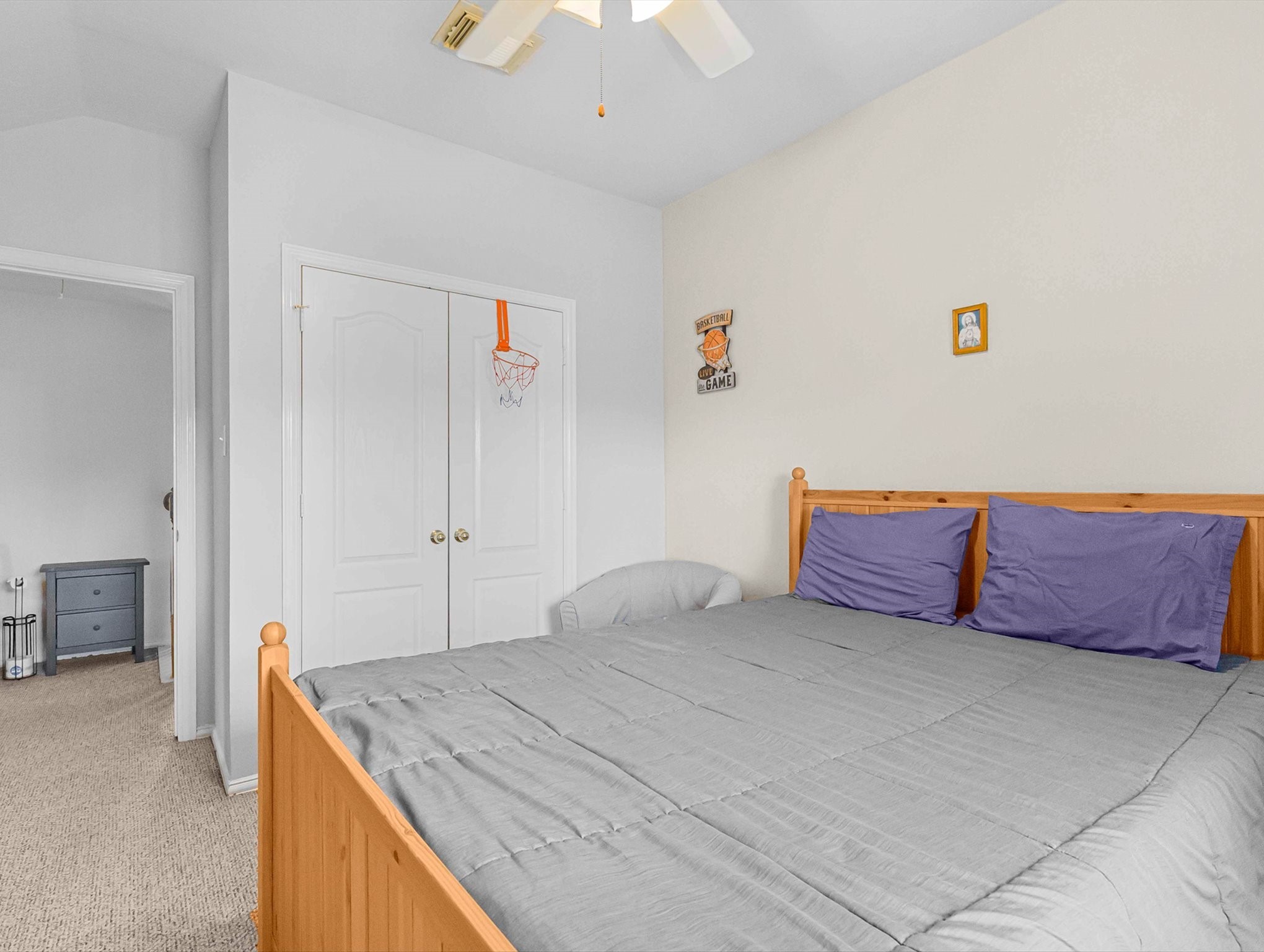 21402 Hannover Forest Spring, TX 77388 - Photo 21 of 30 a bedroom with a large bed and a chandelier