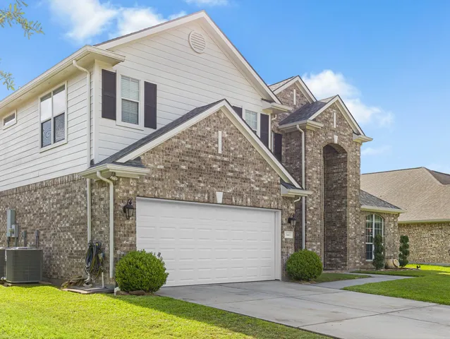 a view of a house with a yard and plants