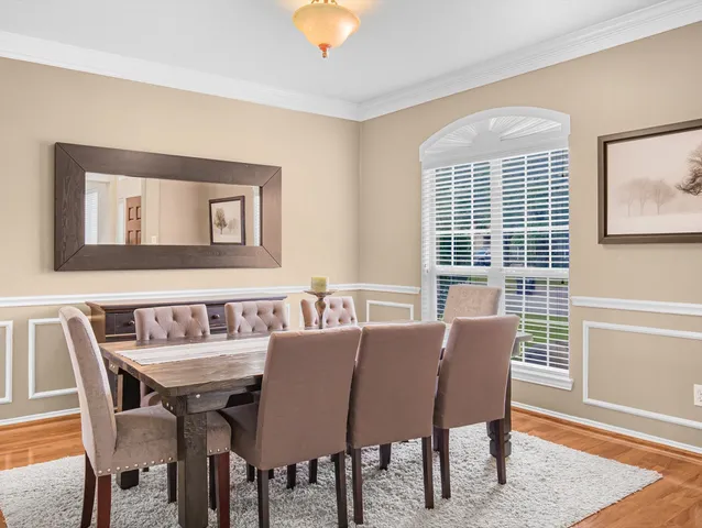 a view of a dining room with furniture window and wooden floor
