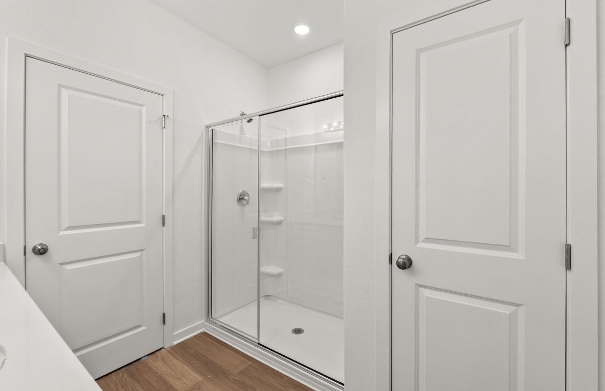 325 Sullivan Way Elgin, TX 78621 - Photo 10 of 19 a bathroom with a shower and a glass door