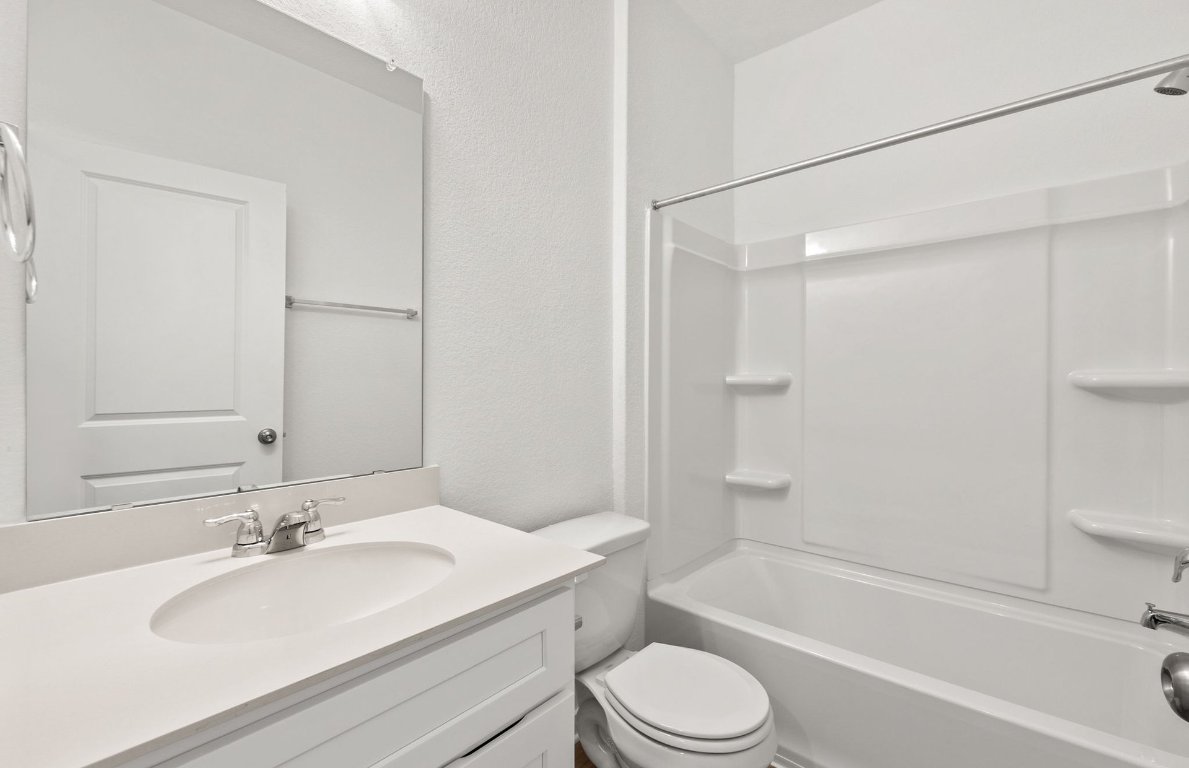 325 Sullivan Way Elgin, TX 78621 - Photo 13 of 19 a bathroom with a granite countertop sink toilet and shower