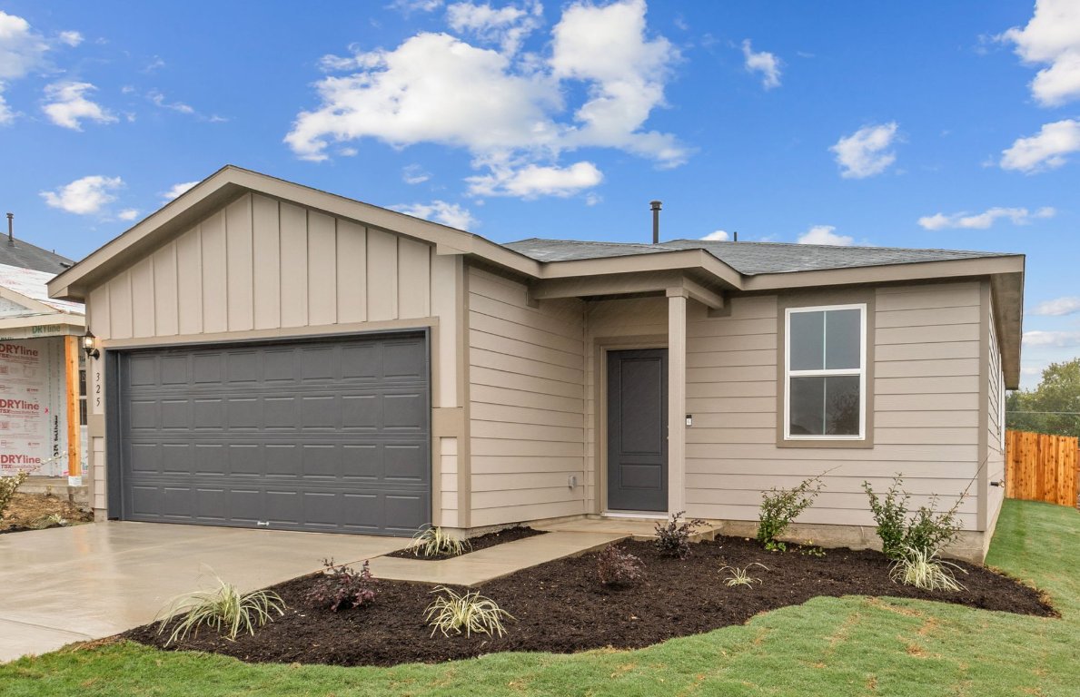 325 Sullivan Way Elgin, TX 78621 - Photo 2 of 19 a front view of a house with a yard
