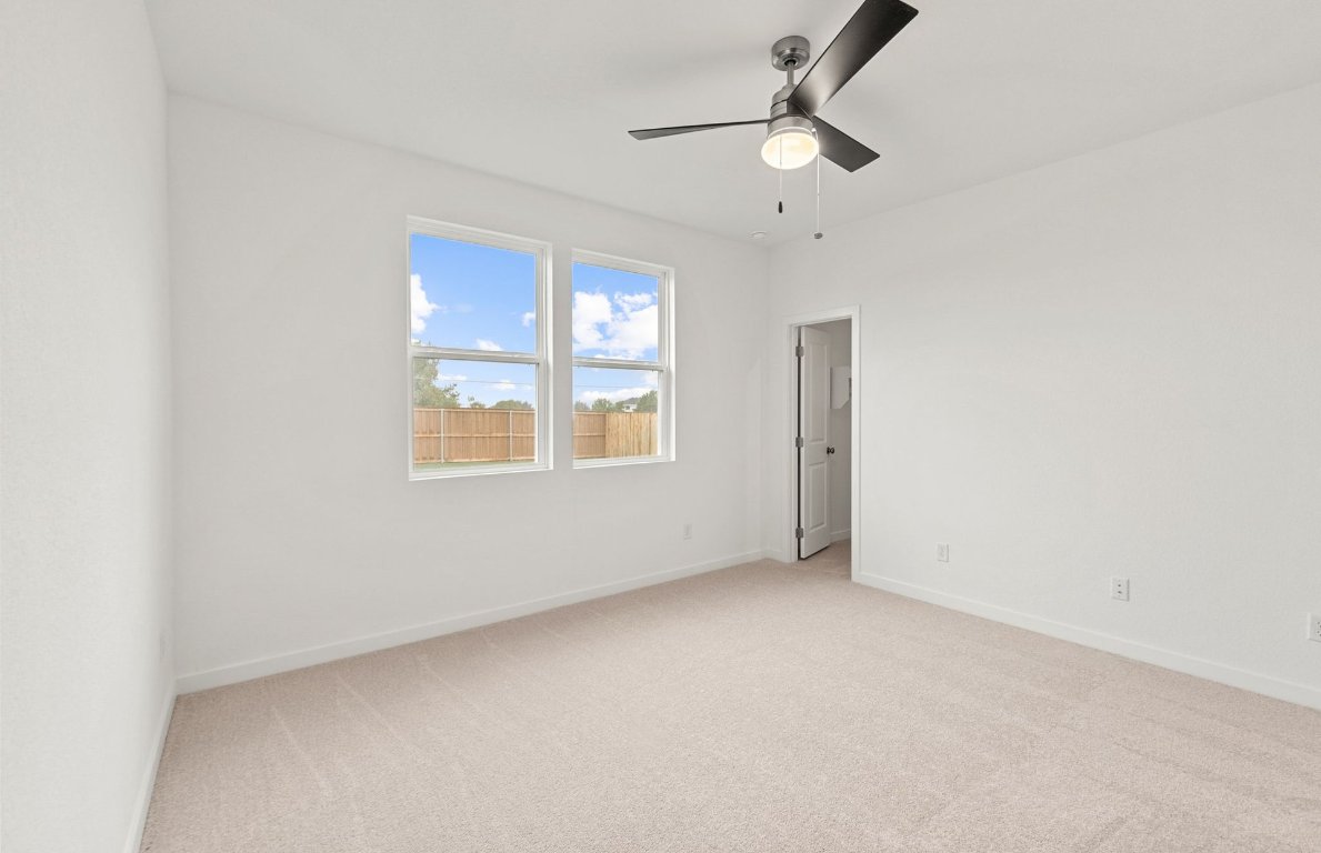 325 Sullivan Way Elgin, TX 78621 - Photo 7 of 19 an empty room with windows and fan
