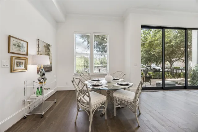 a dining room with furniture and wooden floor