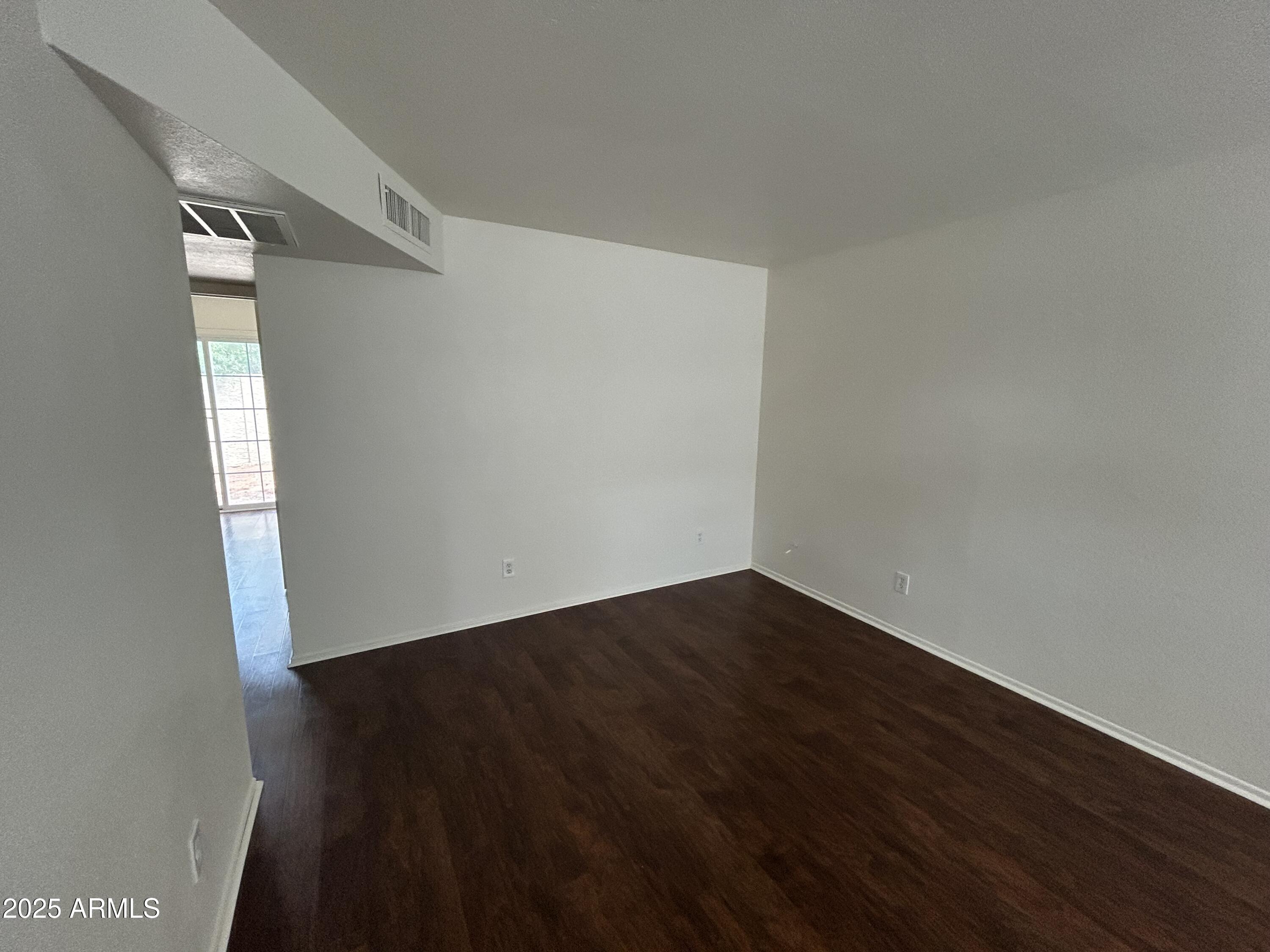 45 North Phyllis, Unit 109 Mesa, AZ 85201 - Photo 12 of 28 an empty room with wooden floor and windows