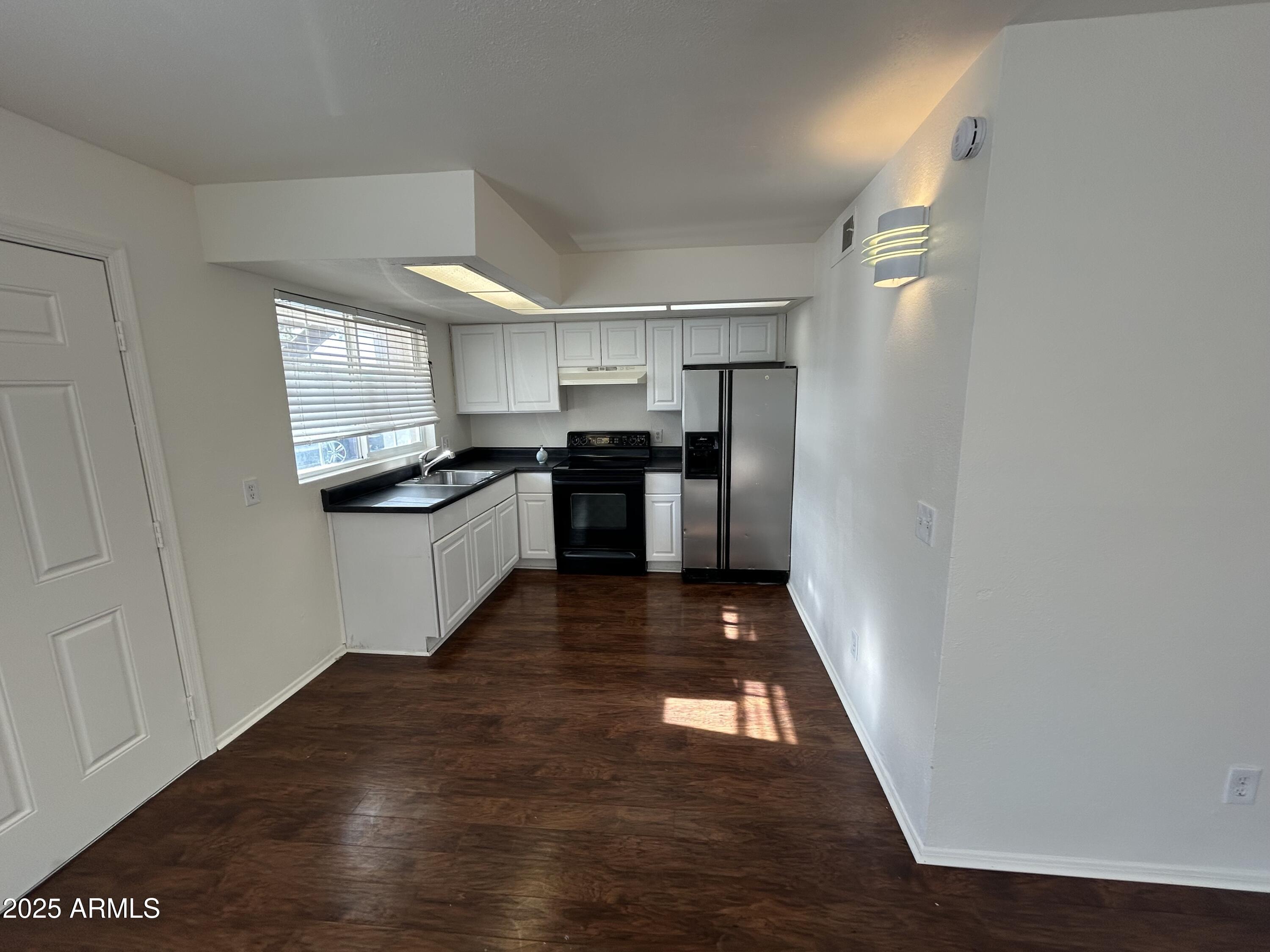 45 North Phyllis, Unit 109 Mesa, AZ 85201 - Photo 2 of 28 a kitchen with refrigerator and cabinets