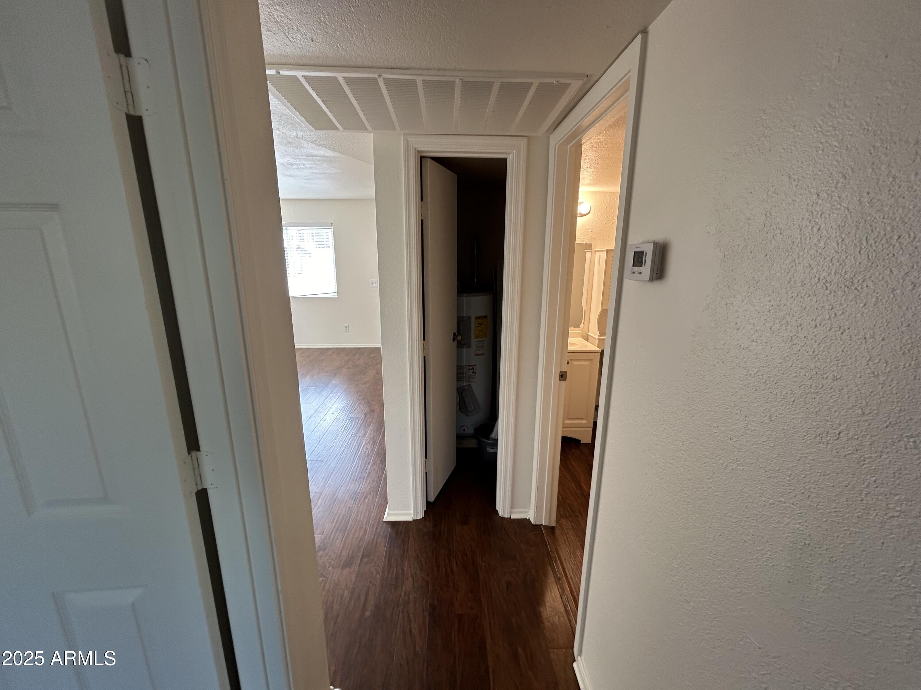 45 North Phyllis, Unit 109 Mesa, AZ 85201 - Photo 22 of 28 a view of a hallway with wooden floor and closet