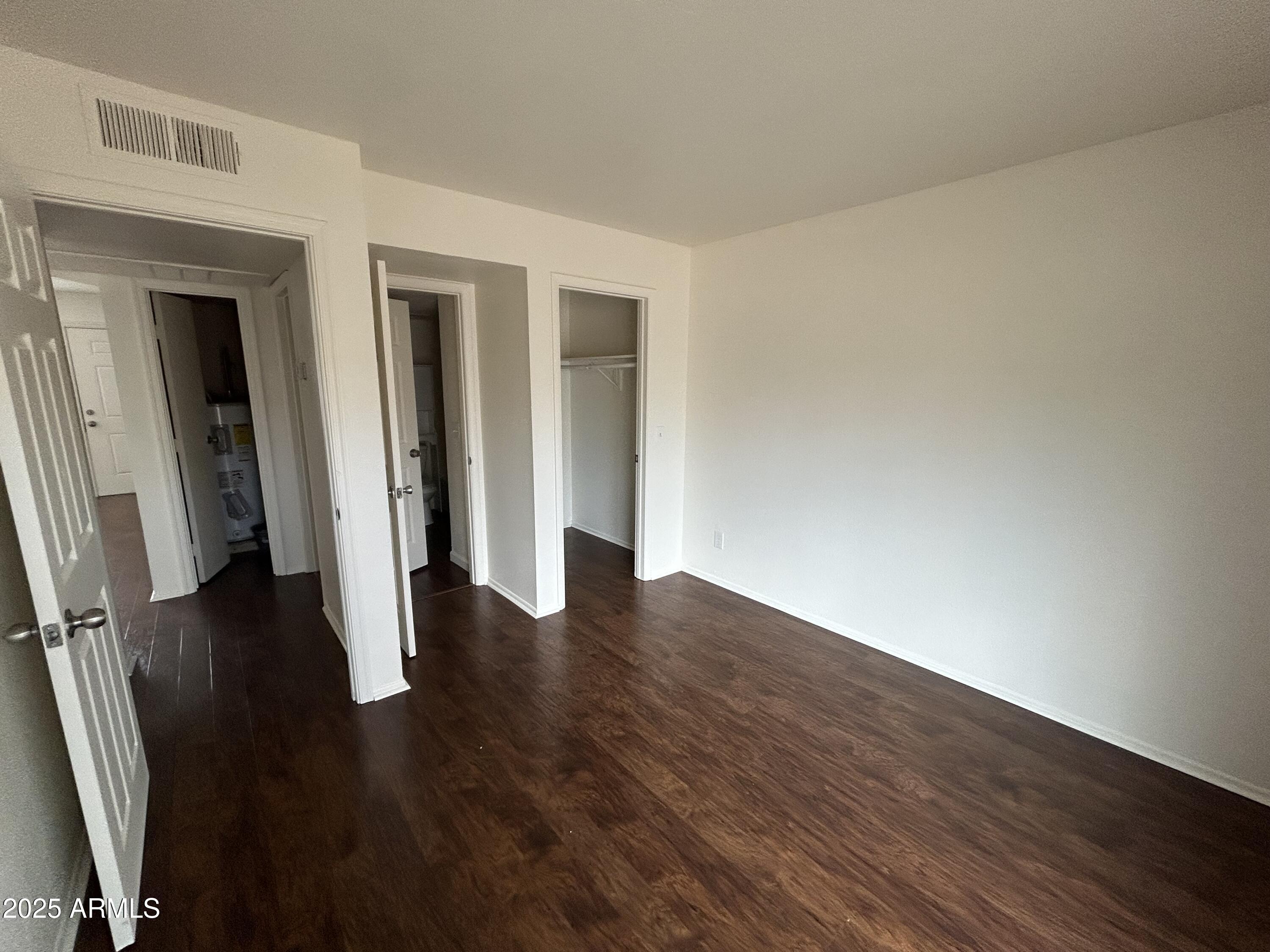 45 North Phyllis, Unit 109 Mesa, AZ 85201 - Photo 23 of 28 a view of an empty room with wooden floor and a window