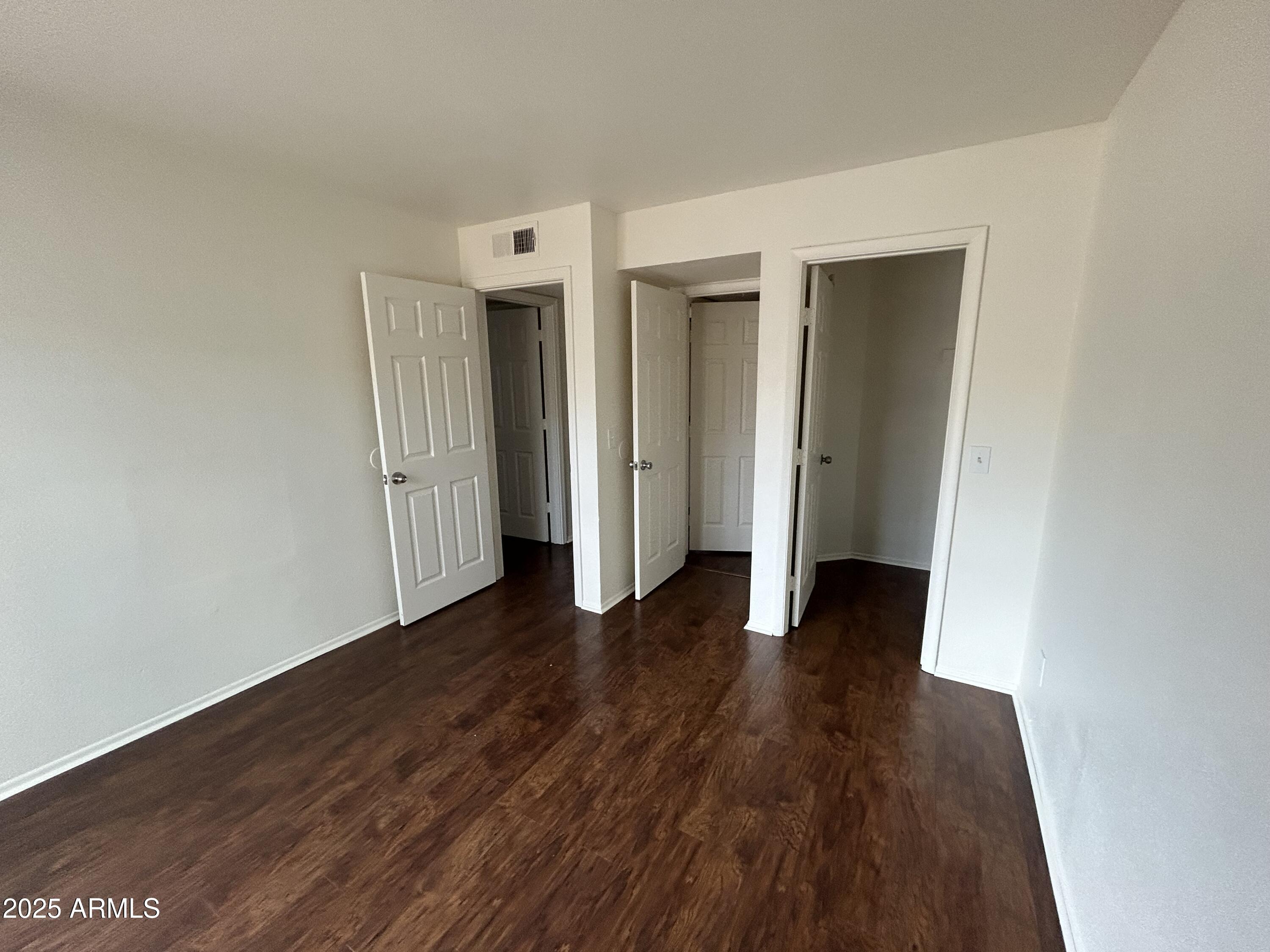 45 North Phyllis, Unit 109 Mesa, AZ 85201 - Photo 28 of 28 a view of an empty room with wooden floor and closet