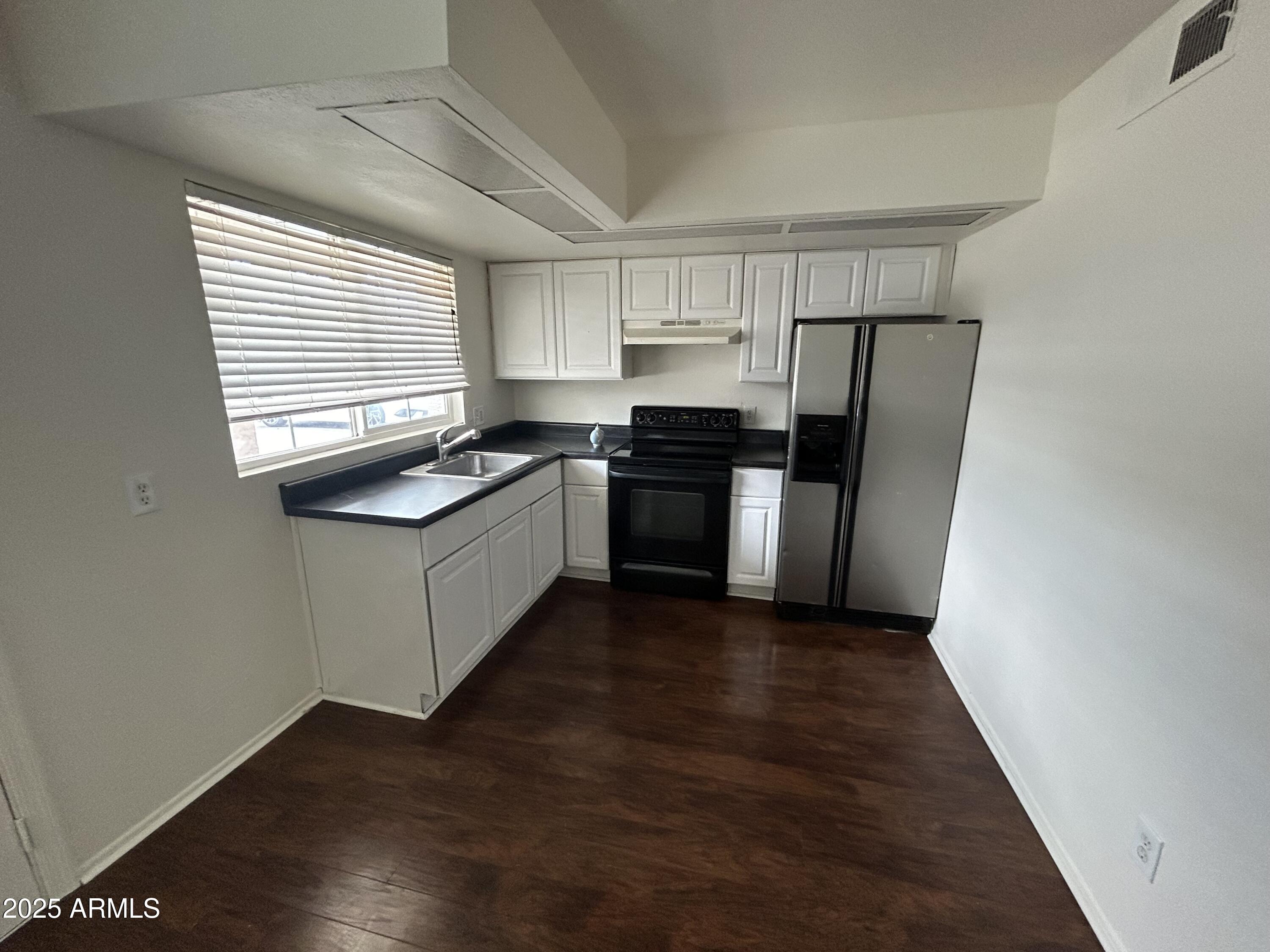 45 North Phyllis, Unit 109 Mesa, AZ 85201 - Photo 3 of 28 a kitchen with a sink a refrigerator and window