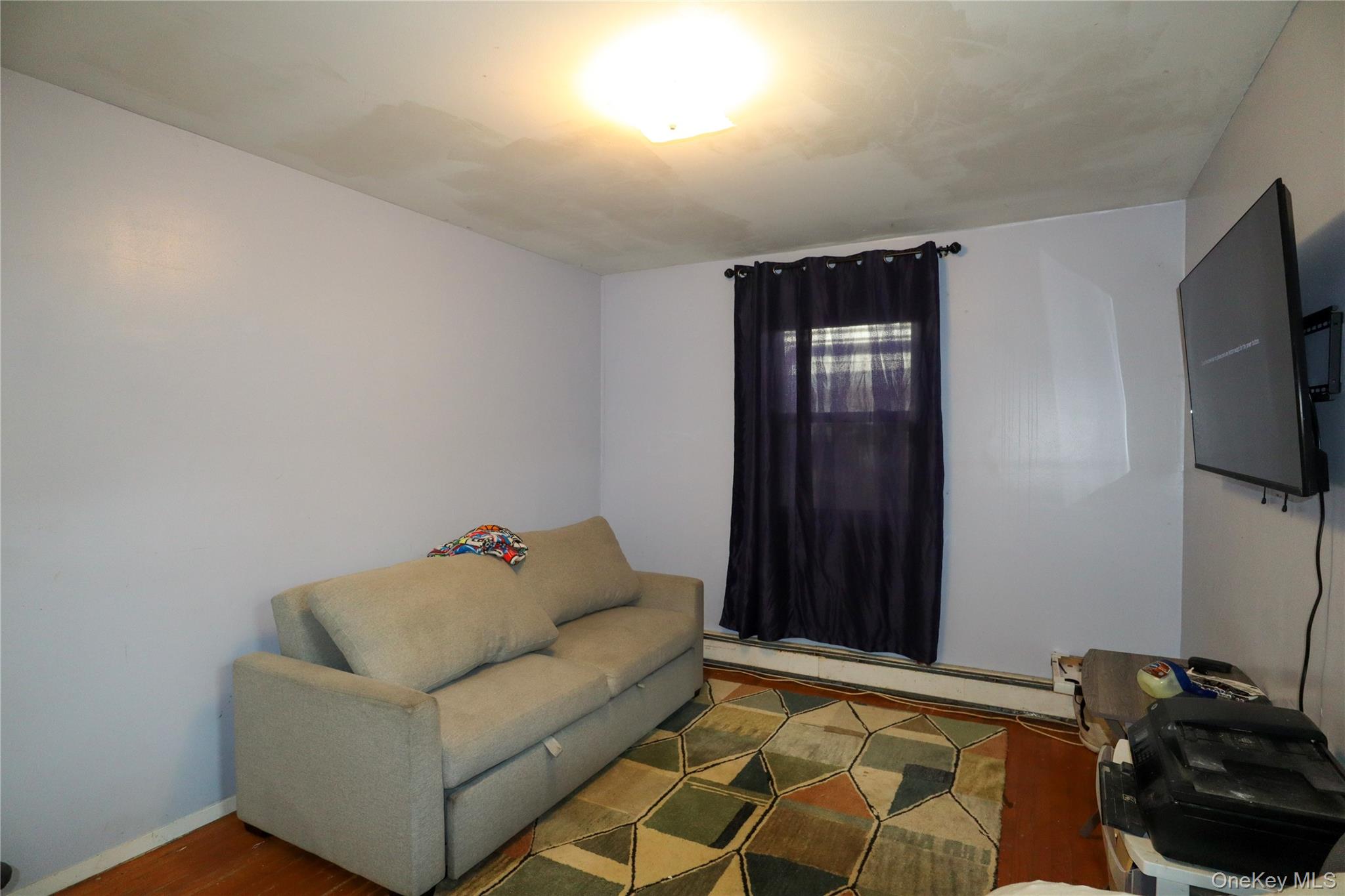 143 Jefferson Avenue Wyandanch, NY 11704 - Photo 11 of 37 a living room with furniture and a flat screen tv