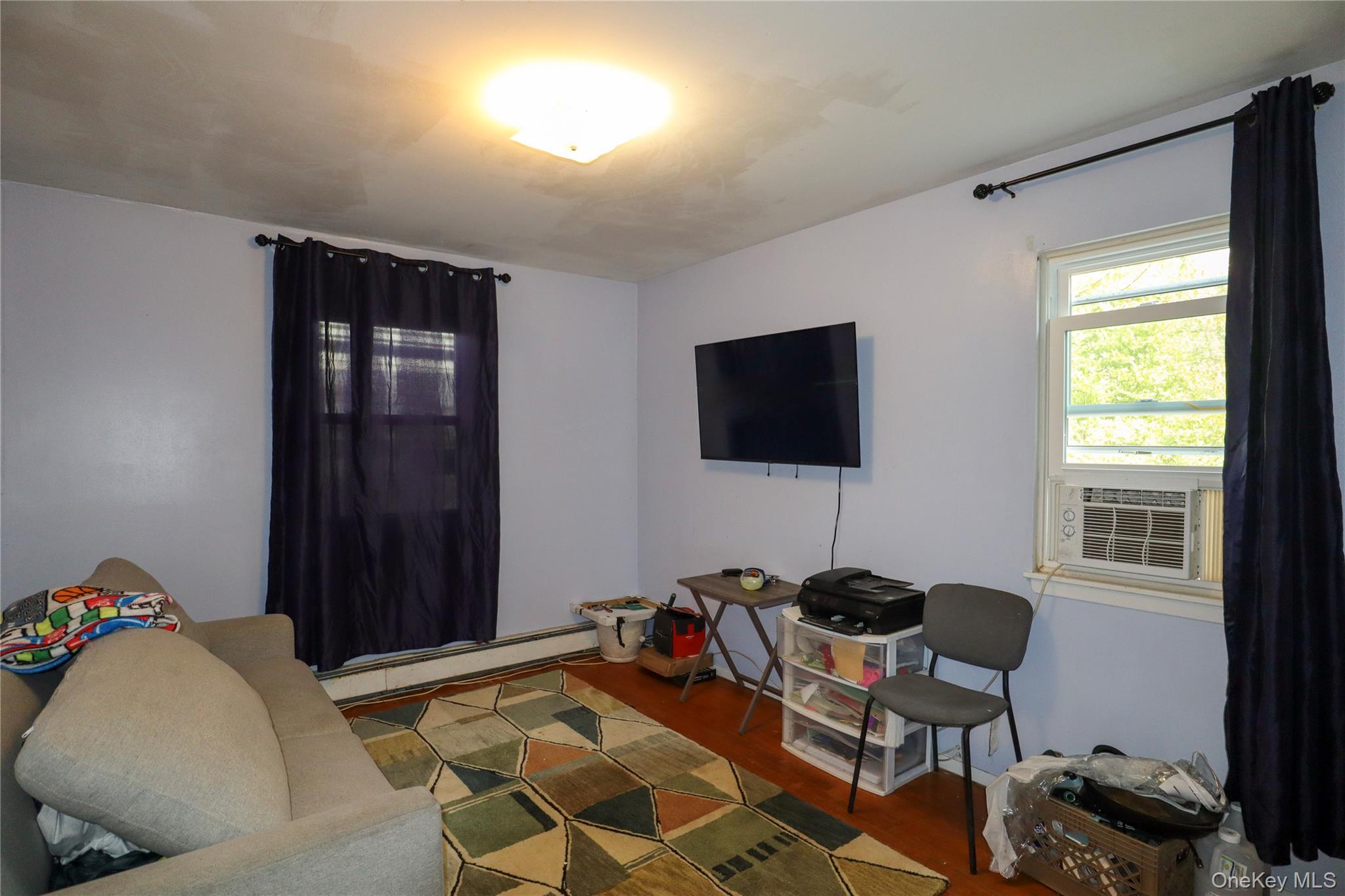 143 Jefferson Avenue Wyandanch, NY 11704 - Photo 12 of 37 a living room with furniture and a flat screen tv