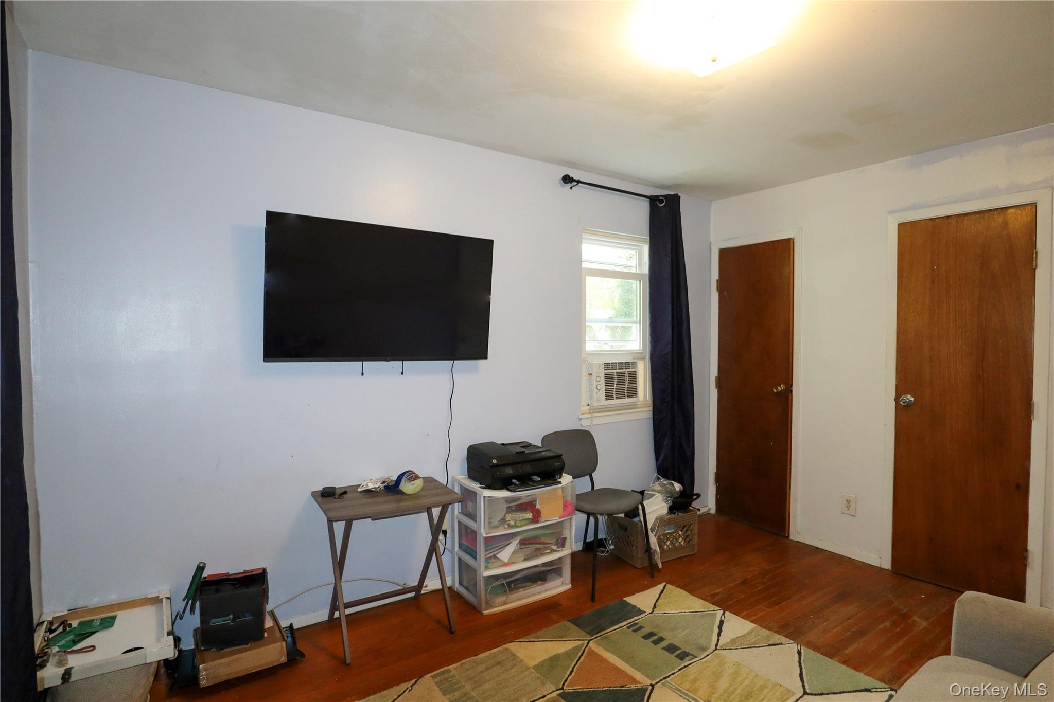 143 Jefferson Avenue Wyandanch, NY 11704 - Photo 13 of 37 a living room with furniture and a flat screen tv