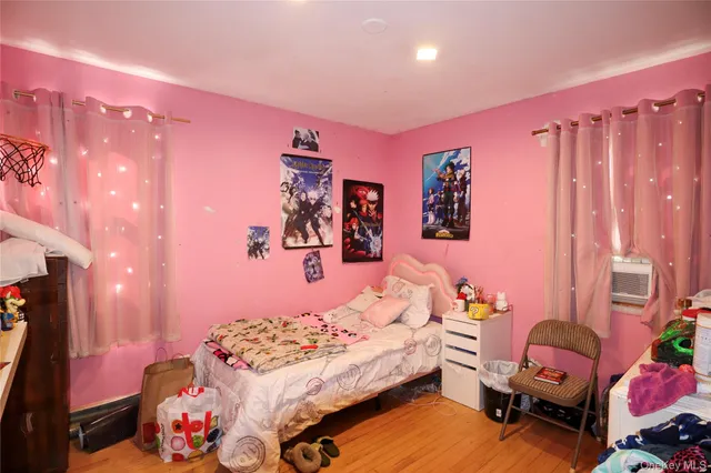 a bedroom with furniture and a flat screen tv