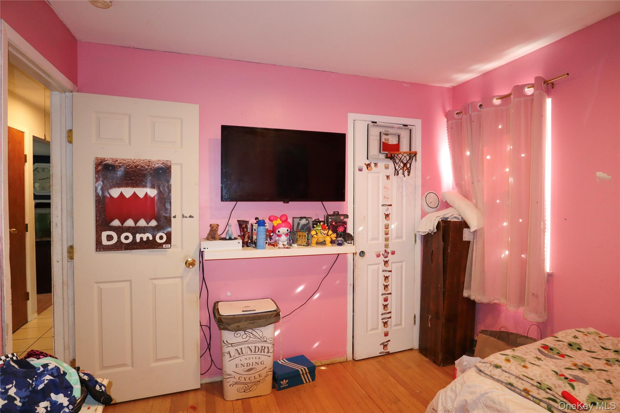 143 Jefferson Avenue Wyandanch, NY 11704 - Photo 18 of 37 a bedroom with furniture and a flat screen tv