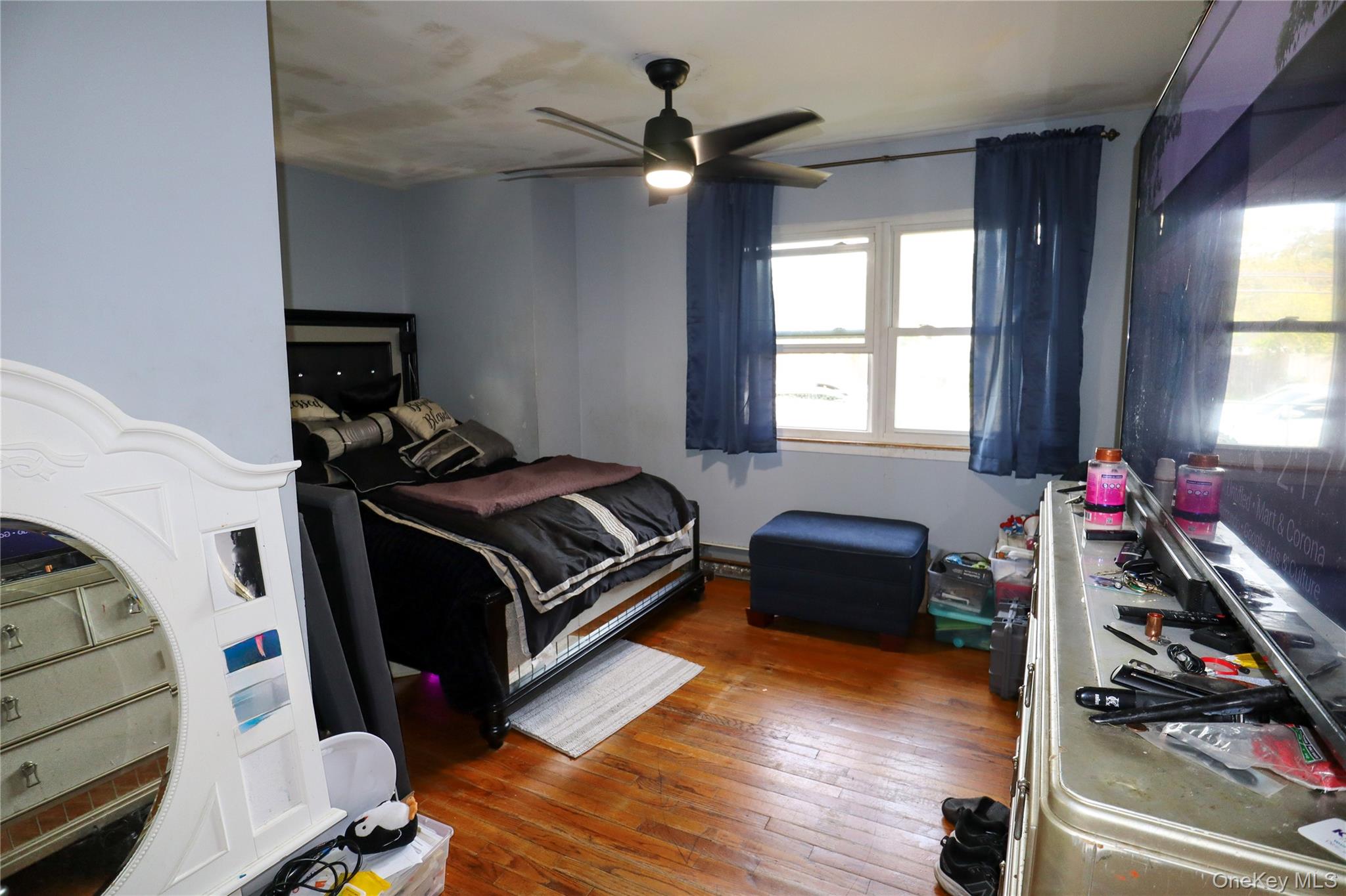 143 Jefferson Avenue Wyandanch, NY 11704 - Photo 19 of 37 a bedroom with a bed and a chandelier