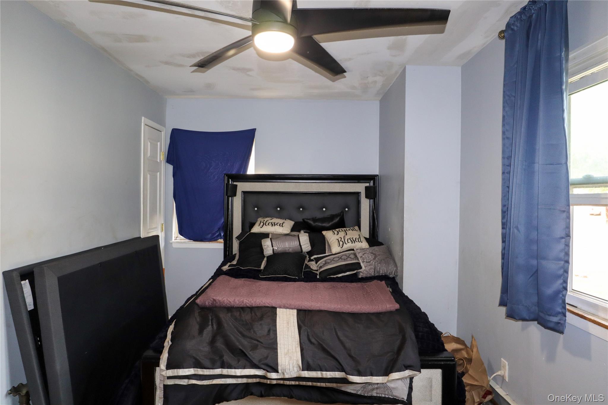 143 Jefferson Avenue Wyandanch, NY 11704 - Photo 21 of 37 a room with a bed and a chandelier