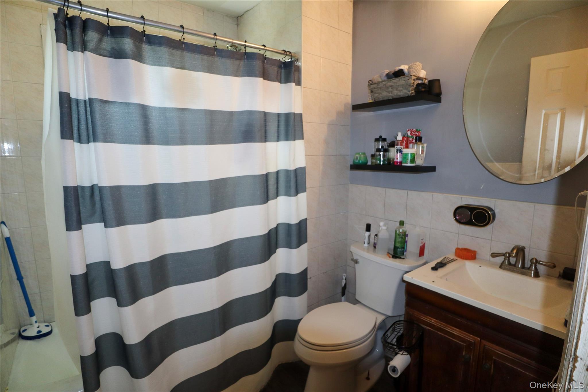 143 Jefferson Avenue Wyandanch, NY 11704 - Photo 22 of 37 a bathroom with a sink toilet and shower