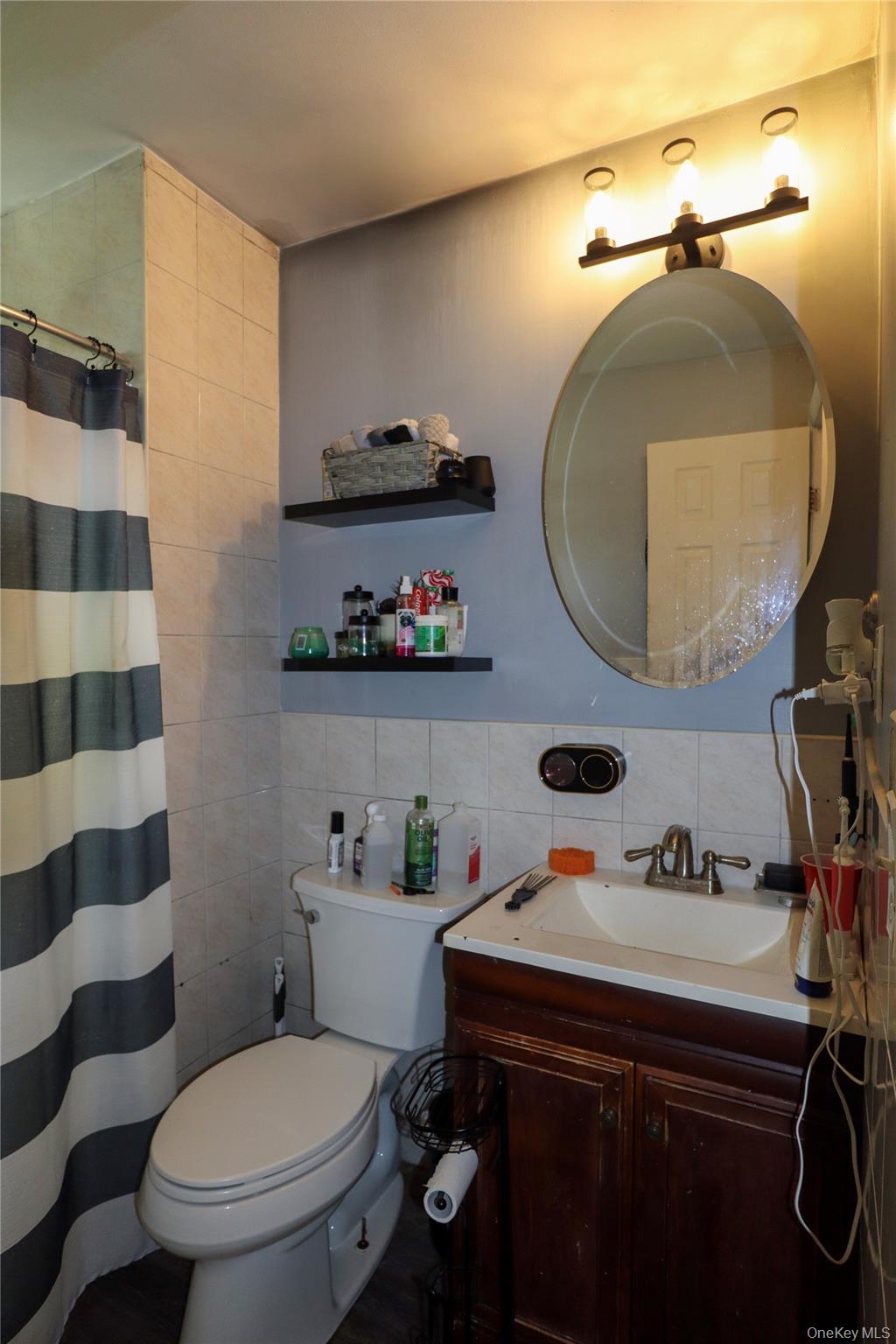 143 Jefferson Avenue Wyandanch, NY 11704 - Photo 23 of 37 a bathroom with a sink a toilet and a mirror