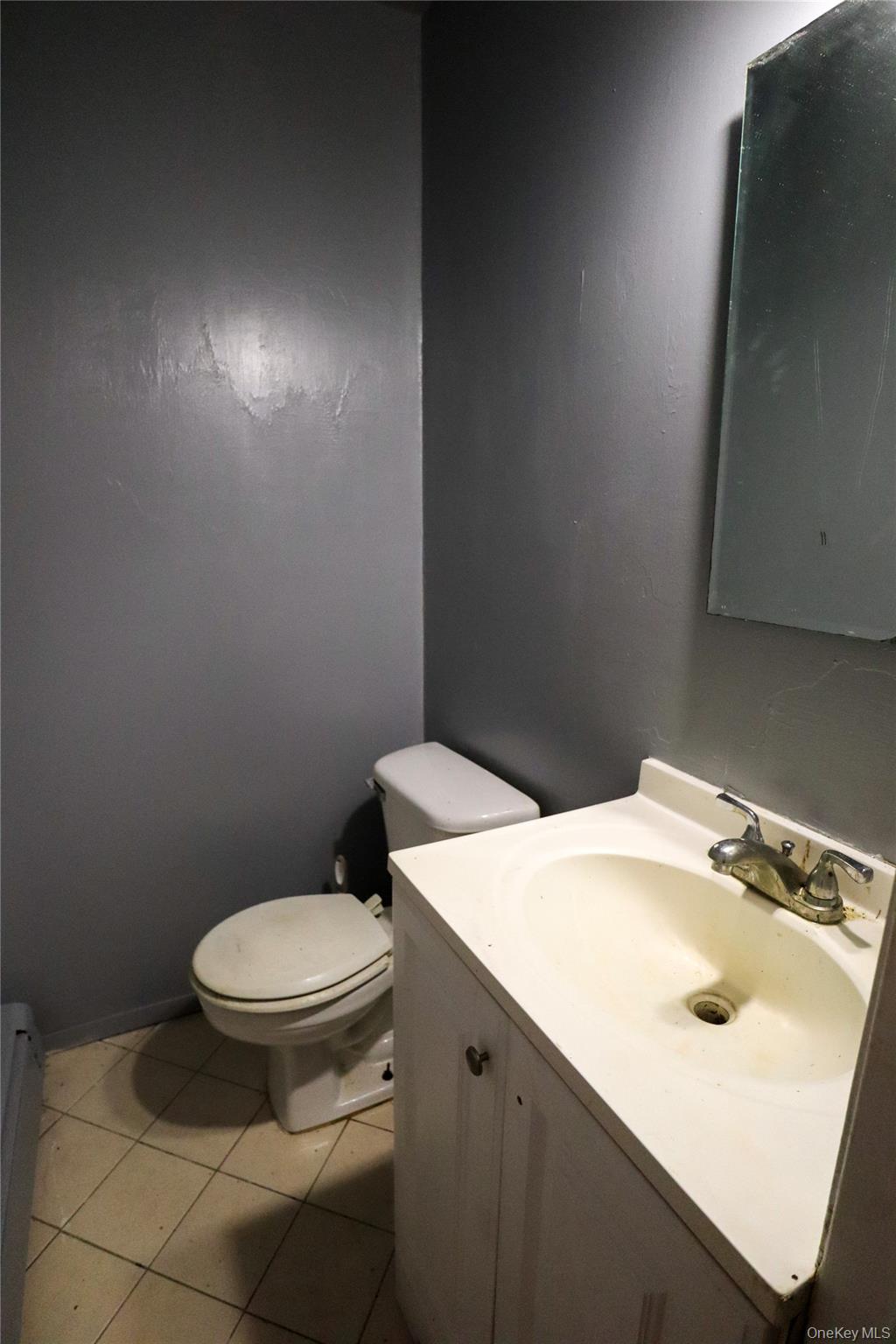 143 Jefferson Avenue Wyandanch, NY 11704 - Photo 24 of 37 a bathroom with a sink toilet and mirror