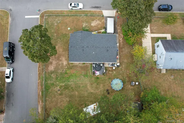 an aerial view of a house with a yard