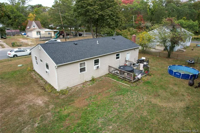 a view of a house with a backyard and a tree