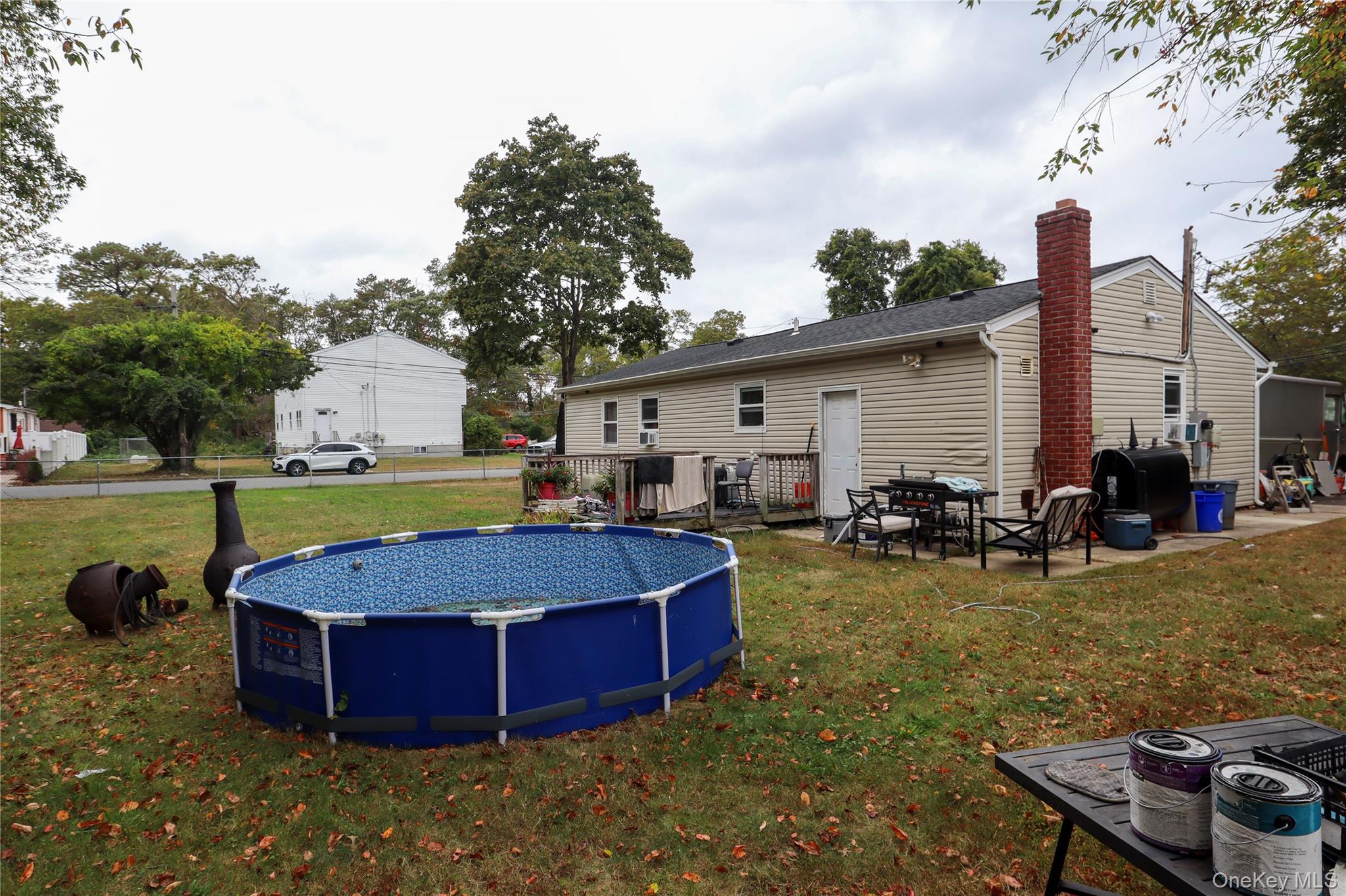 143 Jefferson Avenue Wyandanch, NY 11704 - Photo 36 of 37 a view of a patio with table and chairs with wooden fence