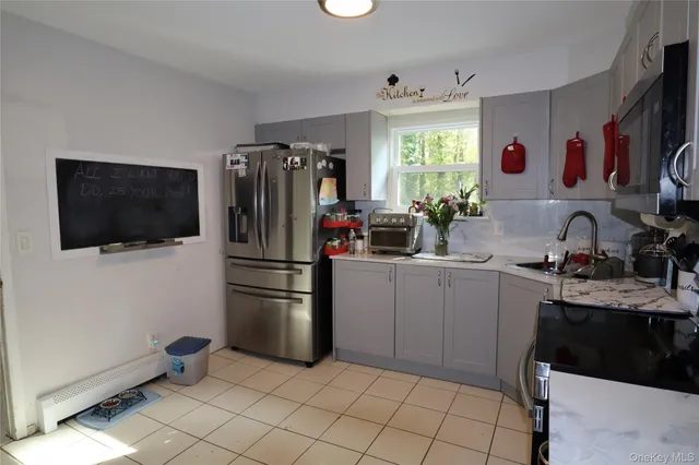 a kitchen with cabinets and stainless steel appliances