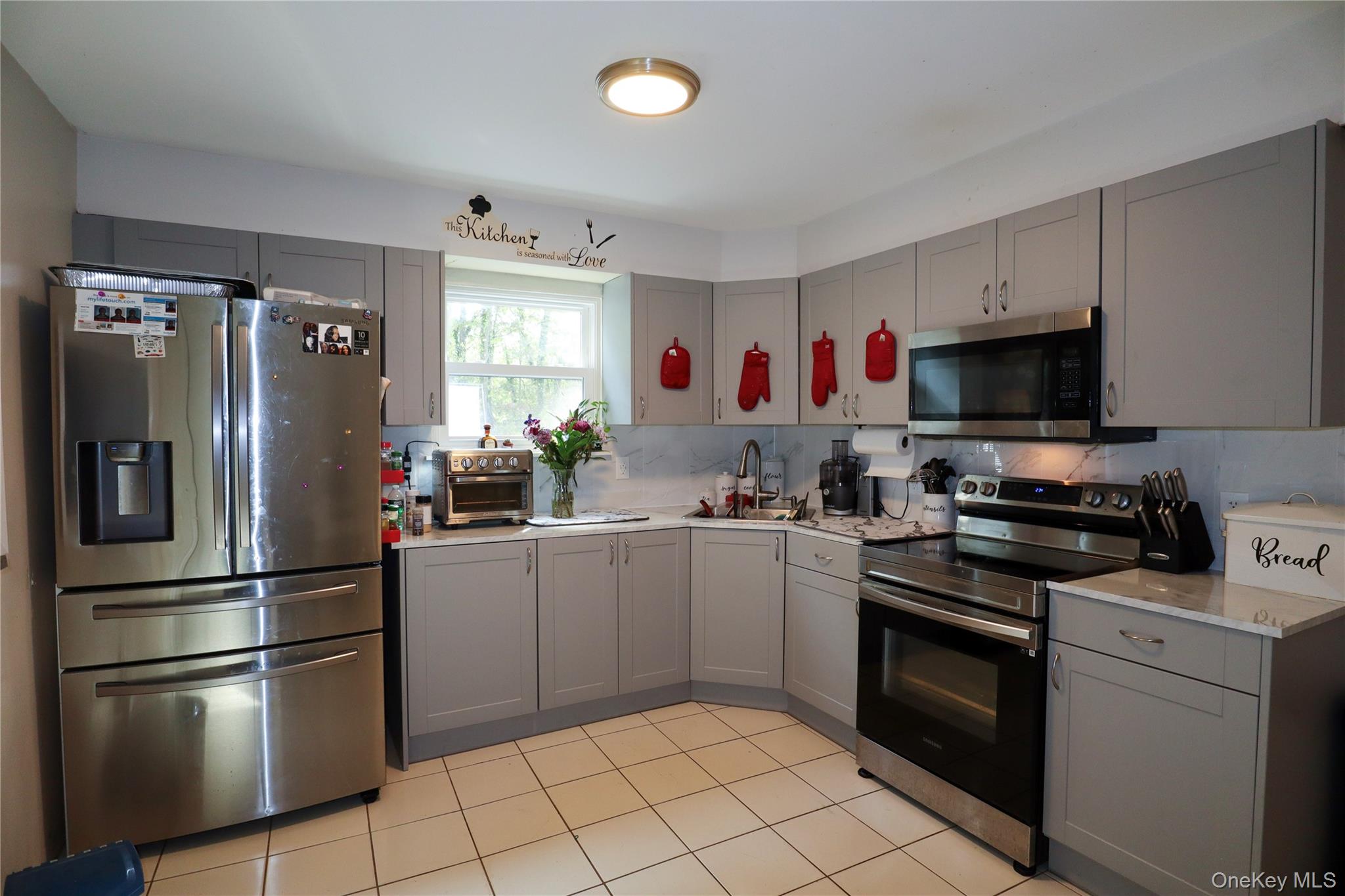 143 Jefferson Avenue Wyandanch, NY 11704 - Photo 7 of 37 a kitchen with cabinets and stainless steel appliances
