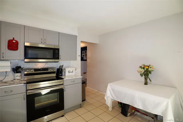 a kitchen with stainless steel appliances a refrigerator sink and microwave