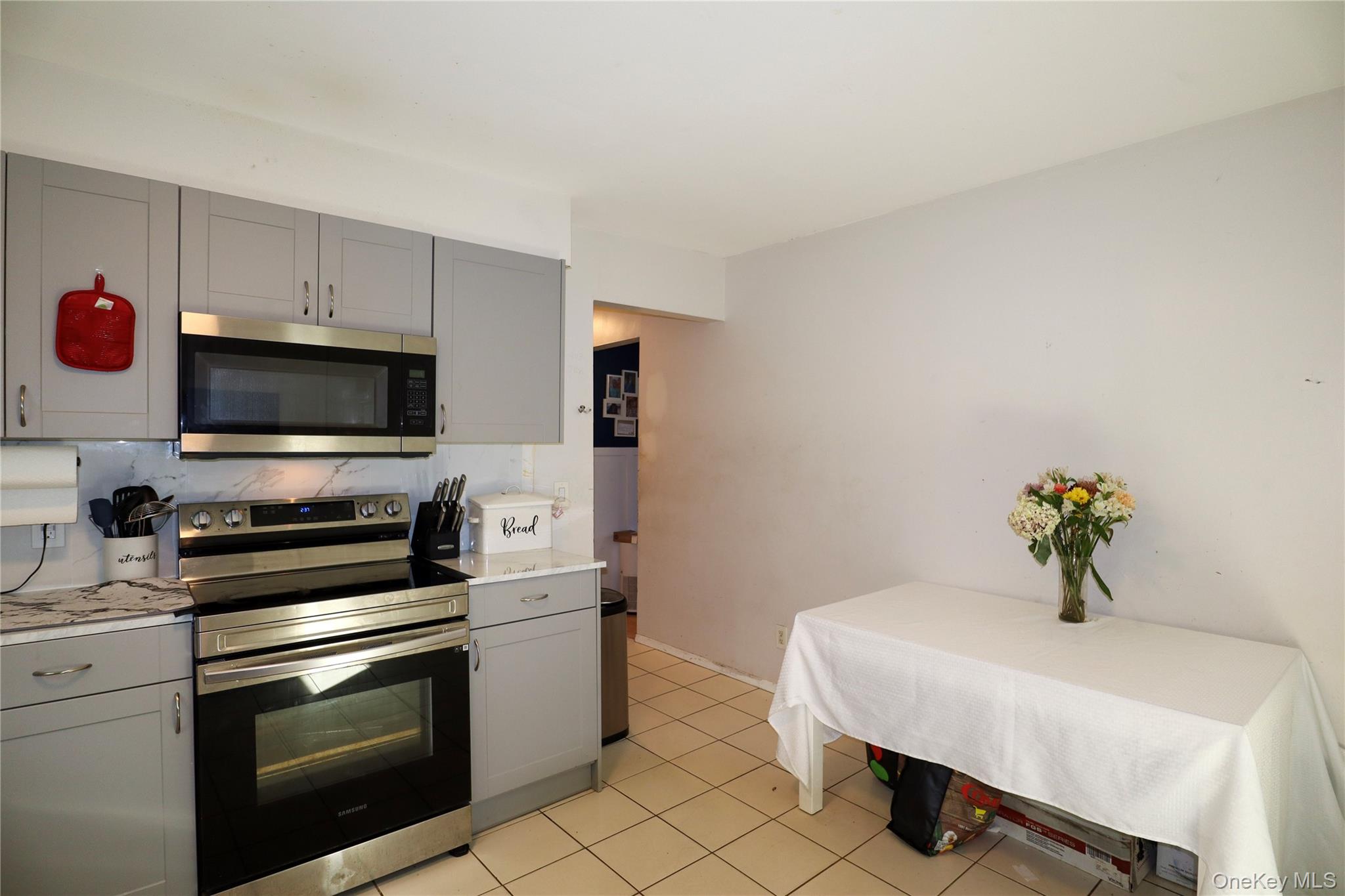 143 Jefferson Avenue Wyandanch, NY 11704 - Photo 8 of 37 a kitchen with stainless steel appliances a stove a sink and a microwave