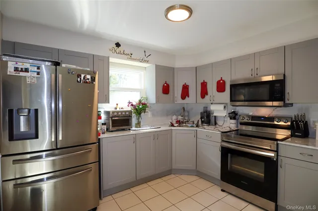 a kitchen with a refrigerator and a sink