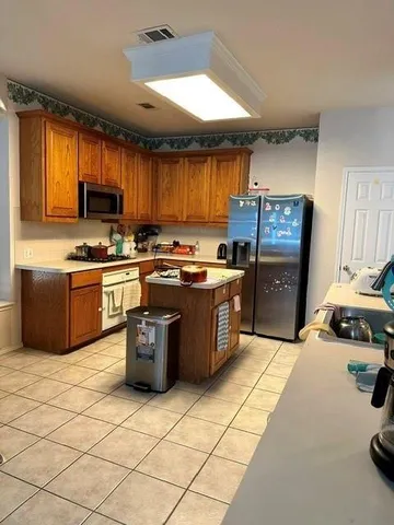 a kitchen with a stove a sink and a microwave
