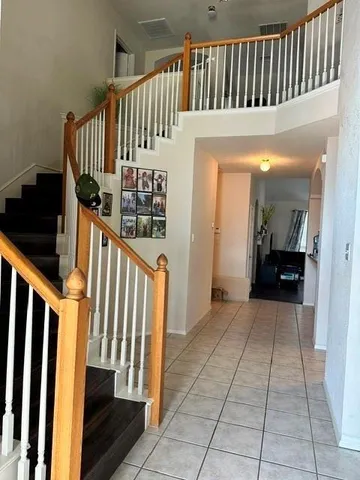 a view of a hallway with wooden floor and staircase