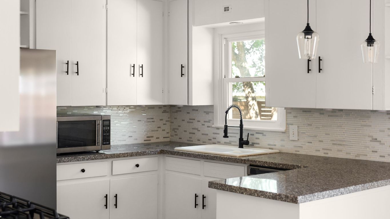 2118 Fordham Lane Austin, TX 78723 - Photo 11 of 28 a kitchen with granite countertop a sink a stove and cabinets