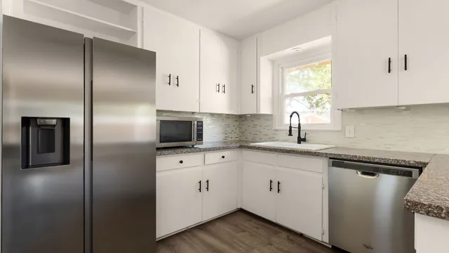 a kitchen with cabinets and stainless steel appliances