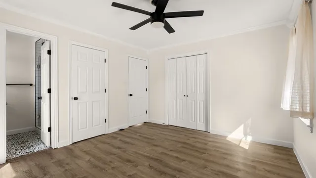 a view of empty room with wooden floor
