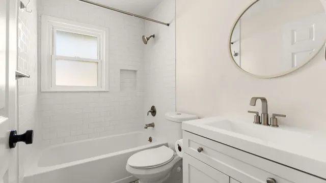 a bathroom with a sink a toilet and a mirror