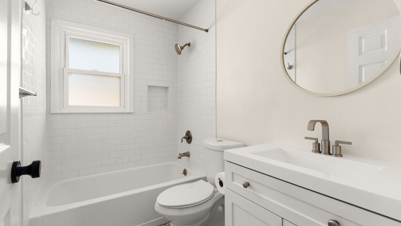 2118 Fordham Lane Austin, TX 78723 - Photo 17 of 28 a bathroom with a sink a toilet and a mirror