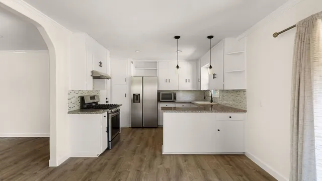 a kitchen with granite countertop a sink and a stove top oven