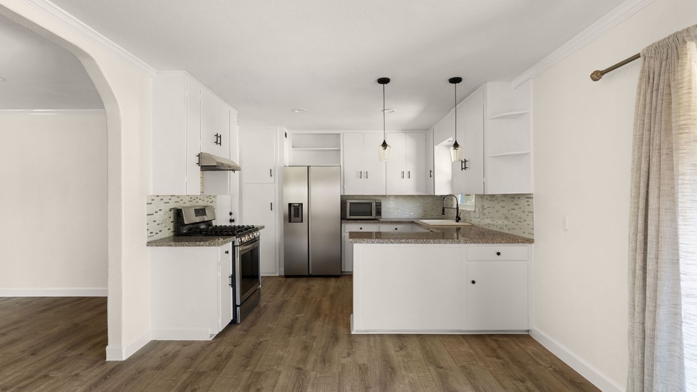 2118 Fordham Lane Austin, TX 78723 - Photo 2 of 28 a kitchen with granite countertop a sink and a stove top oven