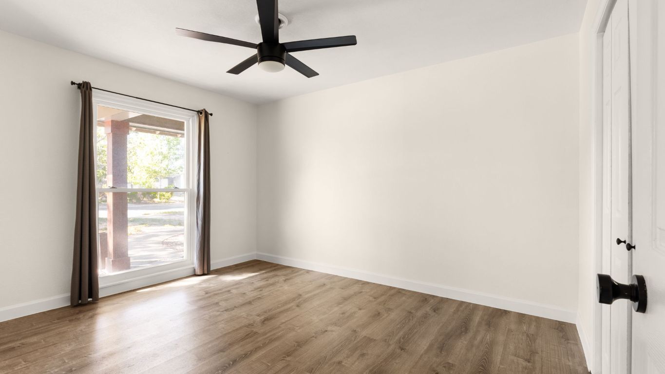 2118 Fordham Lane Austin, TX 78723 - Photo 24 of 28 an empty room with wooden floor fan and windows