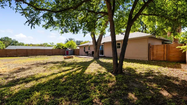 a view of backyard of house with green space