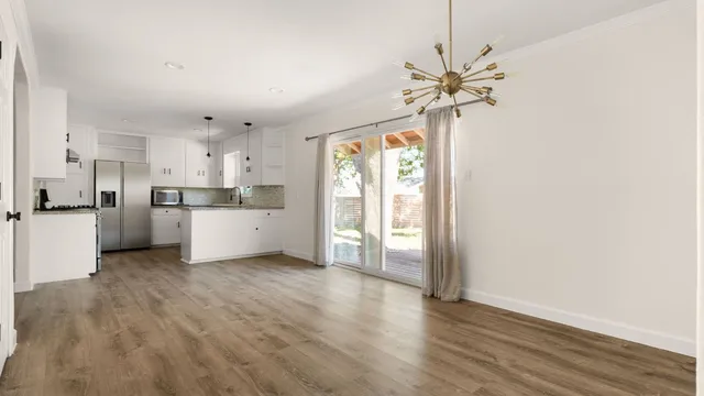 a view of a kitchen with a sink cabinets and wooden floor