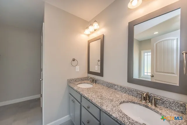 a kitchen with microwave a stove a sink a refrigerator and a window