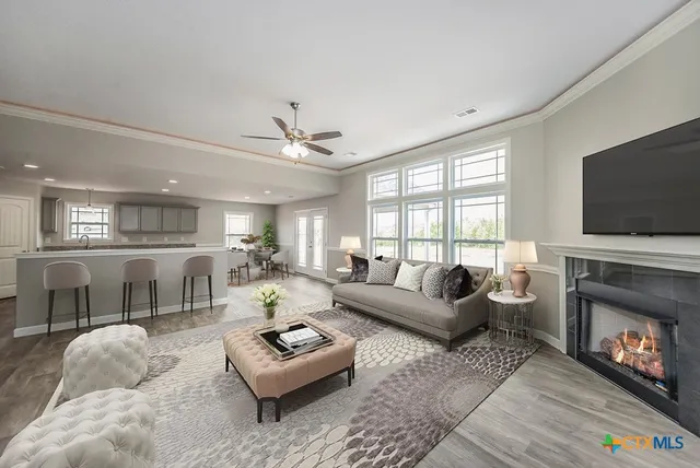 a living room with furniture a fireplace and a flat screen tv