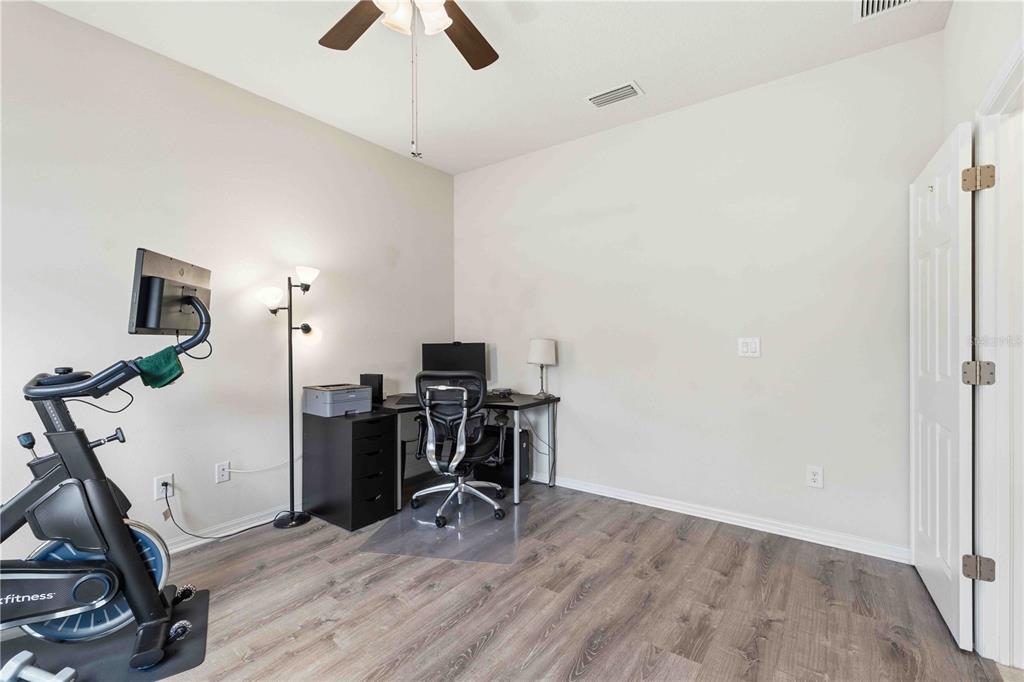 10920 79th Street East Parrish, FL 34219 - Photo 30 of 73 a view of a workspace with furniture and gym equipment