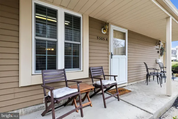 a backyard of a house with outdoor seating