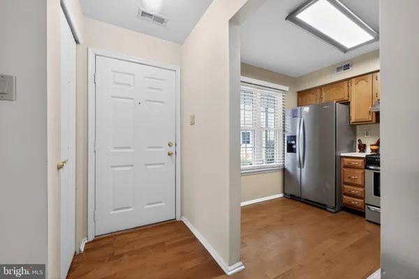 a kitchen with cabinets stainless steel appliances and a sink