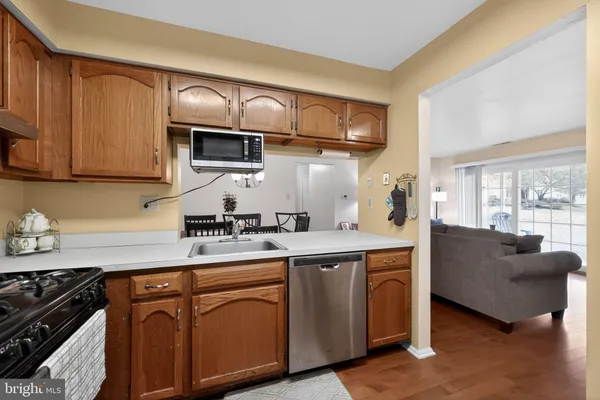 a kitchen with a sink a refrigerator and cabinets